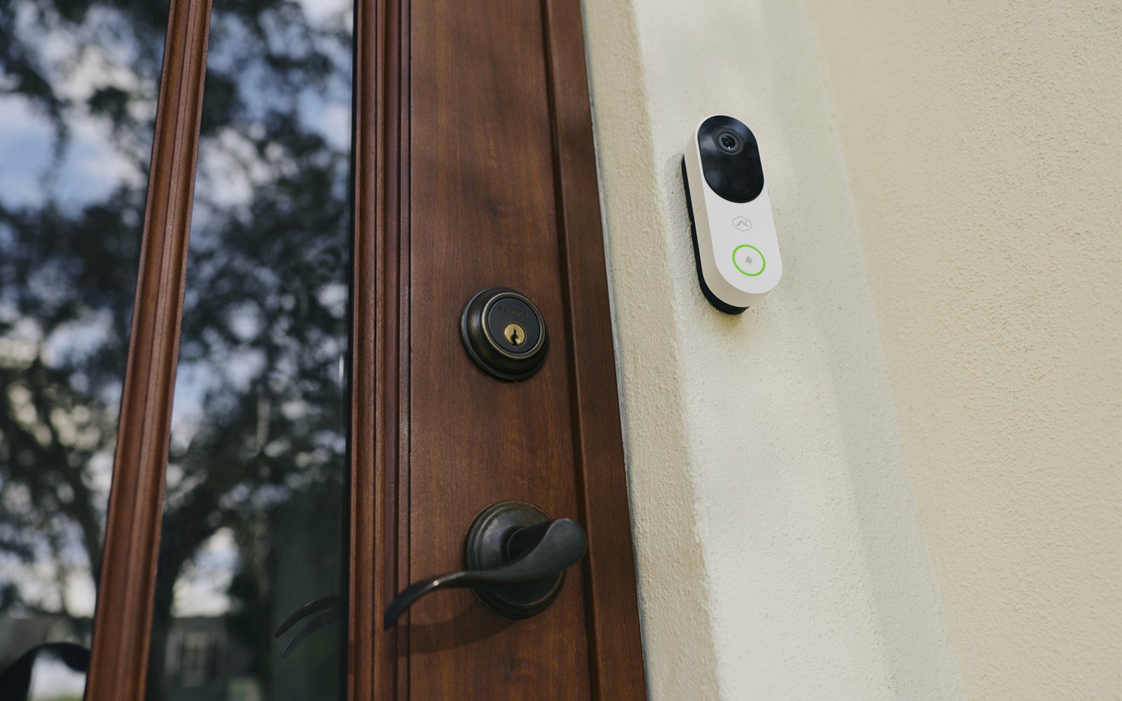 Alarm.com video doorbell installed beside a front door